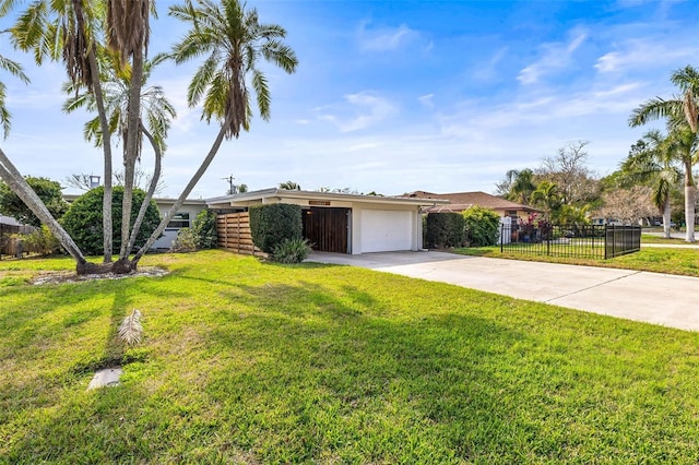 mid-century inspired home with a garage, concrete driveway, a front lawn, and fence