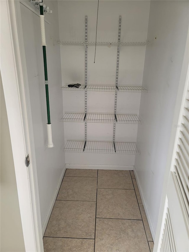 spacious closet with light tile patterned flooring