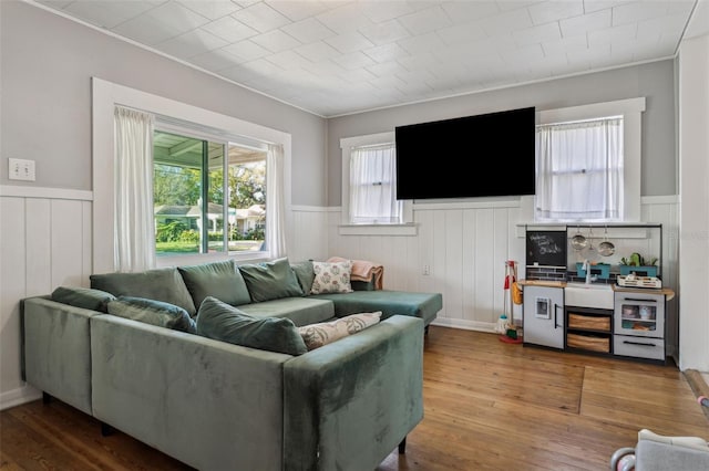 living area featuring wainscoting and hardwood / wood-style flooring