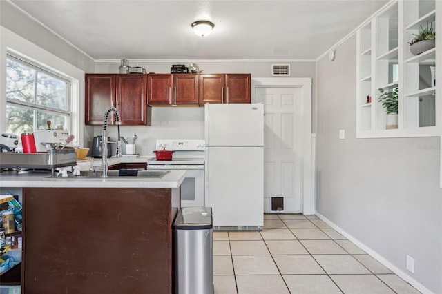 kitchen with visible vents, a sink, light tile patterned flooring, white appliances, and reddish brown cabinets