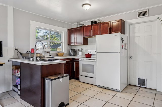 kitchen featuring visible vents, light countertops, light tile patterned floors, white appliances, and a sink