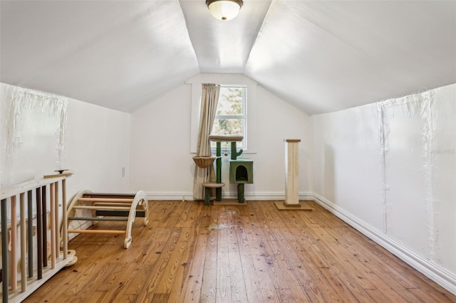 bonus room with vaulted ceiling, baseboards, and hardwood / wood-style flooring