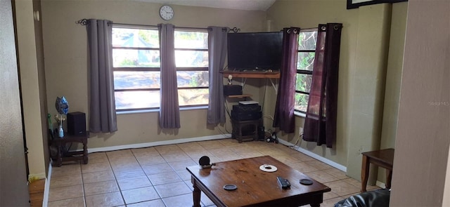 living room with light tile patterned flooring and lofted ceiling