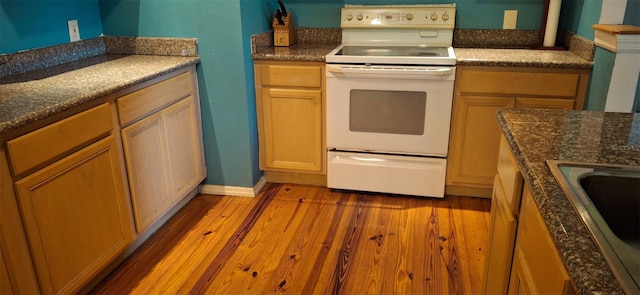 kitchen featuring white electric range and light wood-type flooring