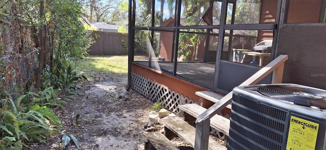 view of yard featuring a wooden deck and central AC