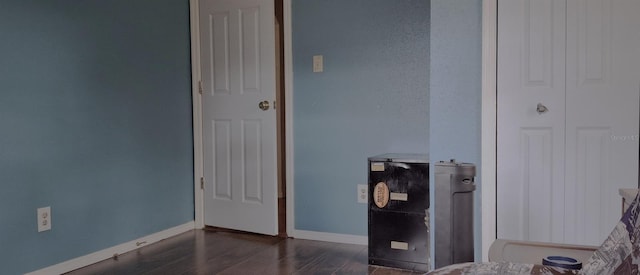 bedroom with dark hardwood / wood-style floors