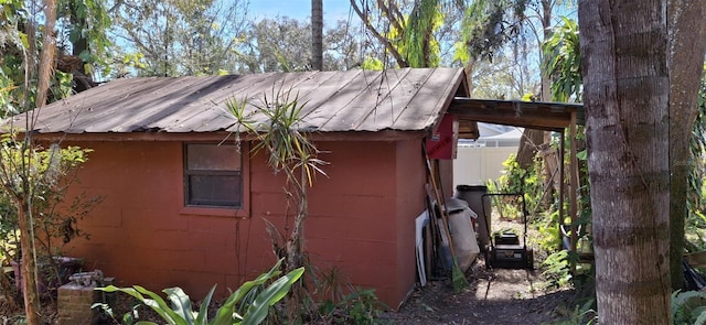 view of home's exterior with a storage shed