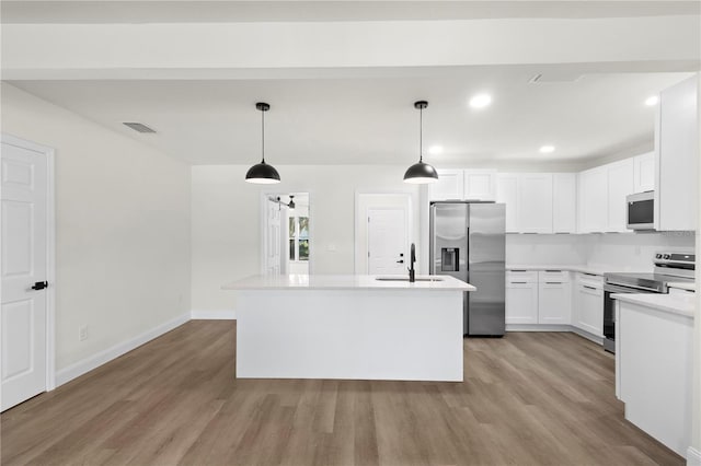 kitchen featuring visible vents, light wood-type flooring, white cabinets, stainless steel appliances, and a sink