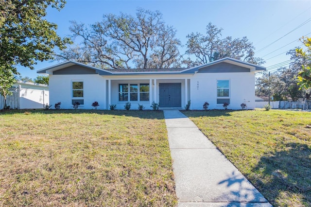 view of front of house with a front lawn and fence