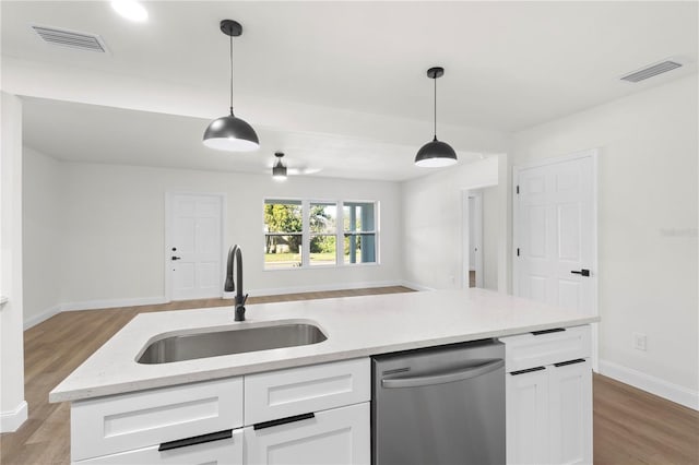 kitchen with dishwasher, open floor plan, visible vents, and a sink