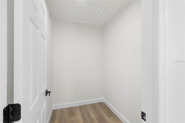 spacious closet with attic access and wood finished floors