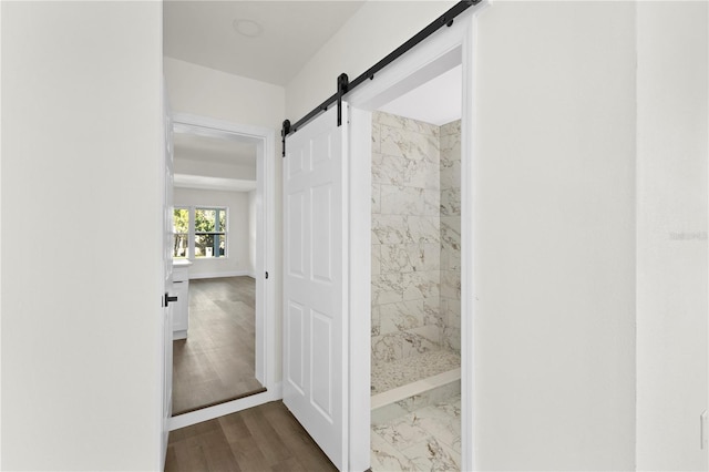 full bathroom featuring wood finished floors and a shower stall