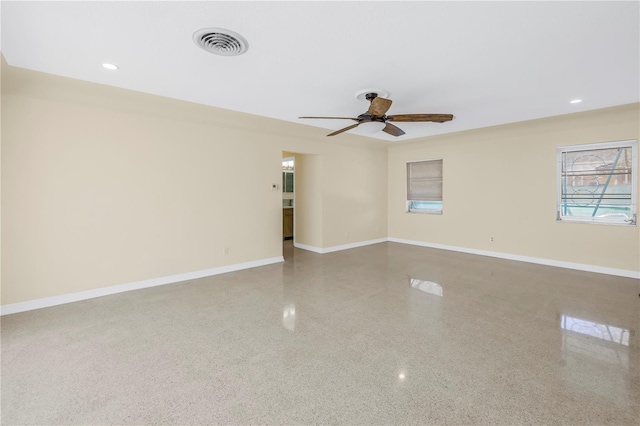 unfurnished room featuring recessed lighting, speckled floor, a ceiling fan, visible vents, and baseboards