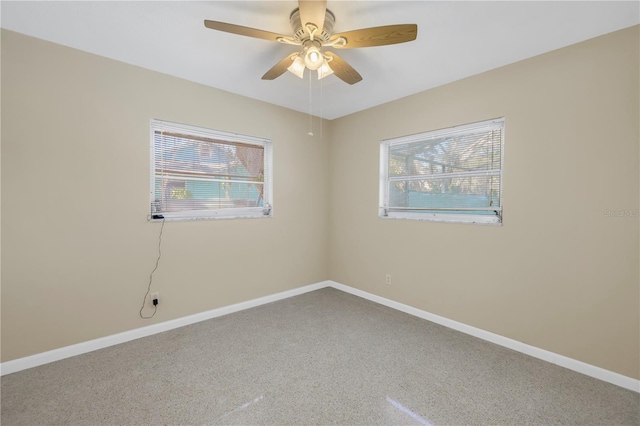 unfurnished room with ceiling fan, carpet flooring, and baseboards