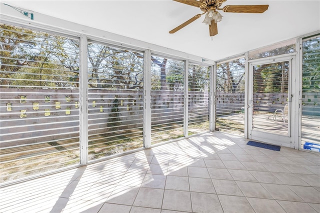 unfurnished sunroom with ceiling fan