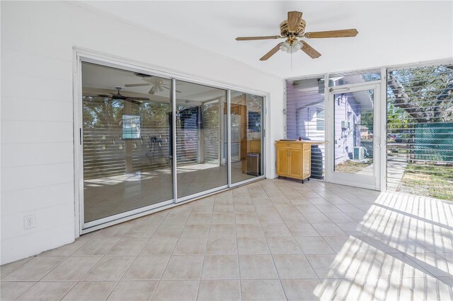 unfurnished sunroom with a ceiling fan