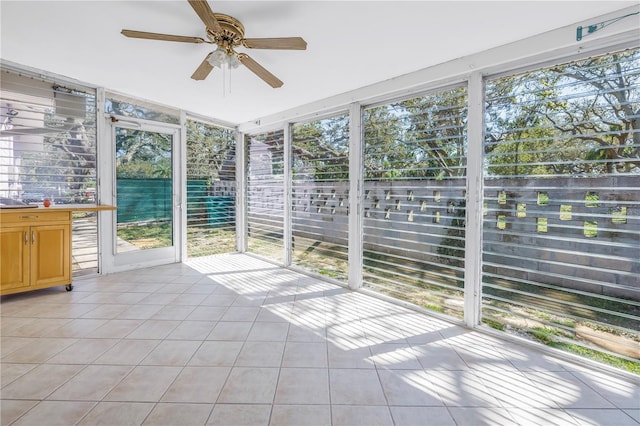 unfurnished sunroom featuring a ceiling fan