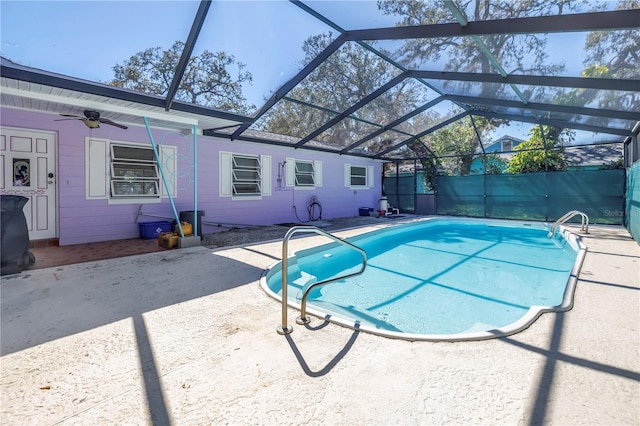 view of pool with a patio area, a ceiling fan, glass enclosure, and a fenced in pool