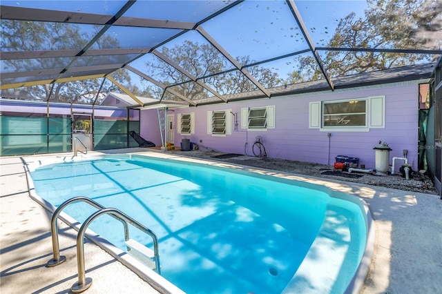 outdoor pool with glass enclosure and a patio