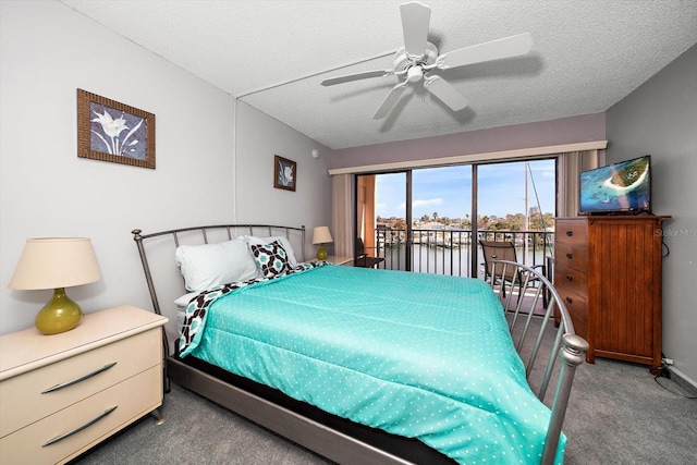 carpeted bedroom featuring ceiling fan, access to outside, and a textured ceiling