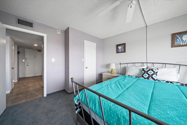 carpeted bedroom featuring a textured ceiling