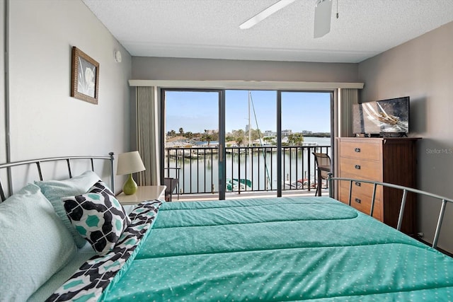 bedroom with ceiling fan, a textured ceiling, and access to outside