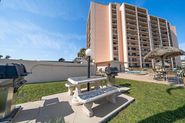 exterior space featuring a community pool and a grill