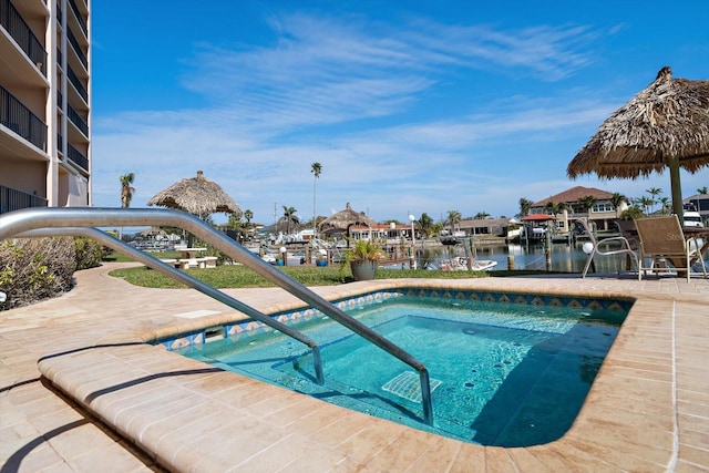 view of swimming pool with a water view