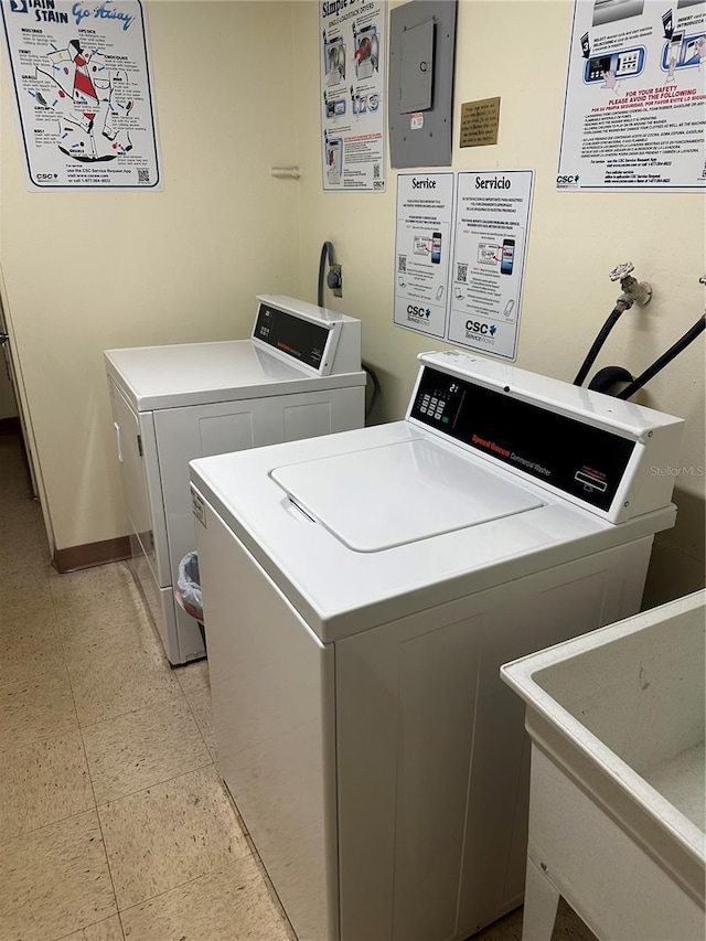 laundry area with separate washer and dryer and sink