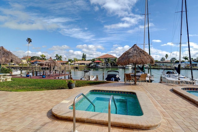 view of pool featuring a water view, a hot tub, and a gazebo