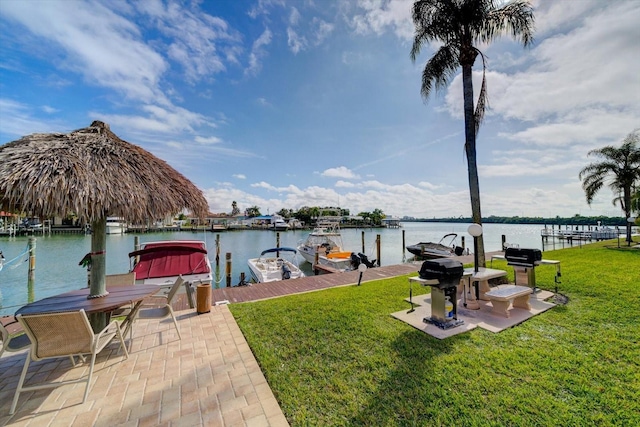 view of dock with a water view and a yard