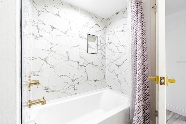 bathroom with shower / tub combo and hardwood / wood-style floors