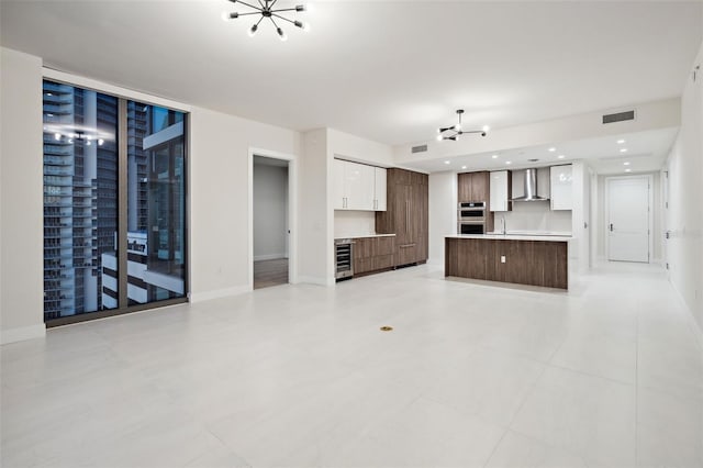 unfurnished living room featuring sink and beverage cooler