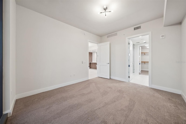 unfurnished bedroom featuring light carpet