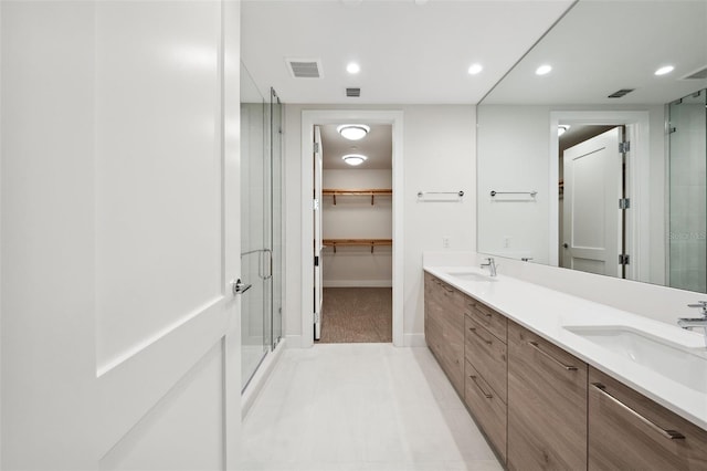 bathroom with vanity, tile patterned flooring, and an enclosed shower