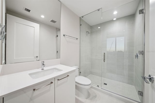 bathroom with toilet, a shower with shower door, and vanity