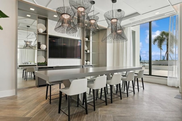 dining room with hardwood / wood-style flooring and a chandelier