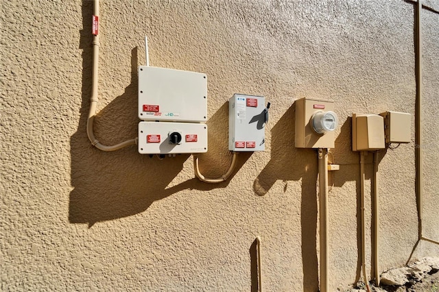 exterior details with electric meter and stucco siding