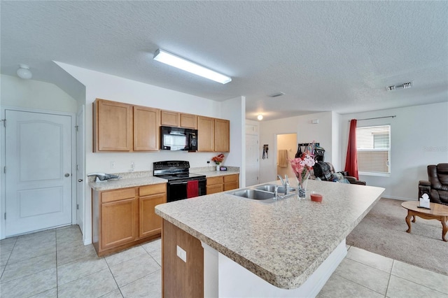 kitchen with an island with sink, open floor plan, light countertops, black appliances, and a sink