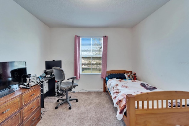 bedroom featuring light carpet and a textured ceiling