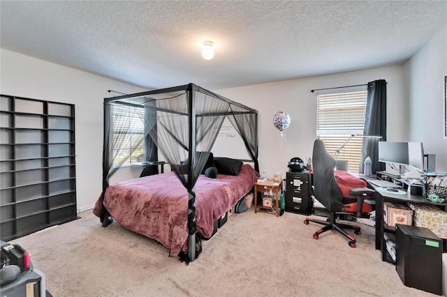 bedroom with a textured ceiling and carpet flooring