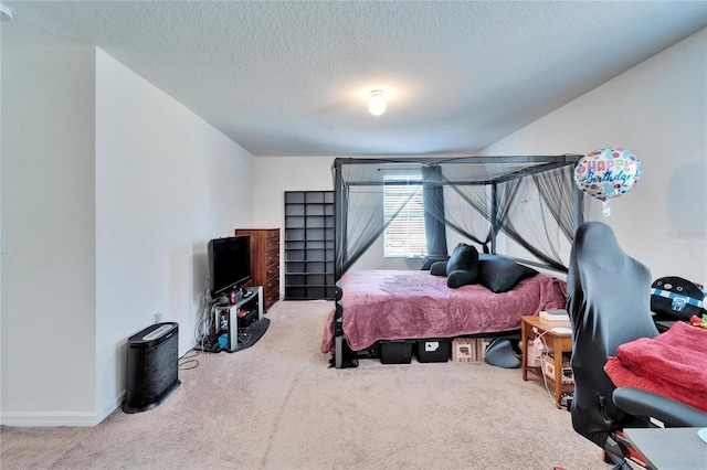 carpeted bedroom featuring a textured ceiling and baseboards