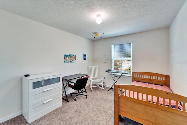 bedroom featuring baseboards, a textured ceiling, and light colored carpet