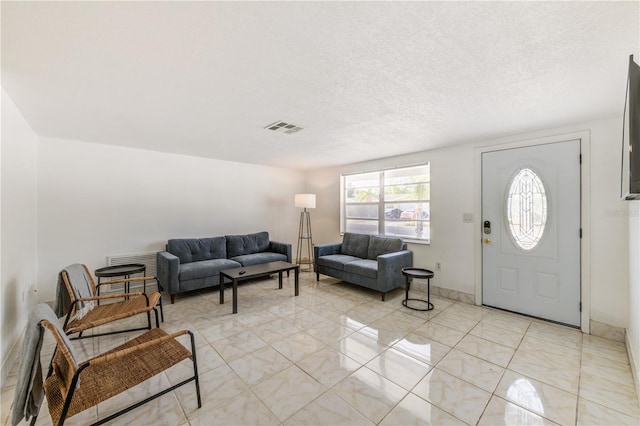 living room with a textured ceiling