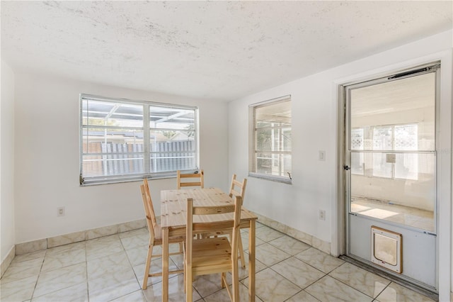 dining area with a textured ceiling