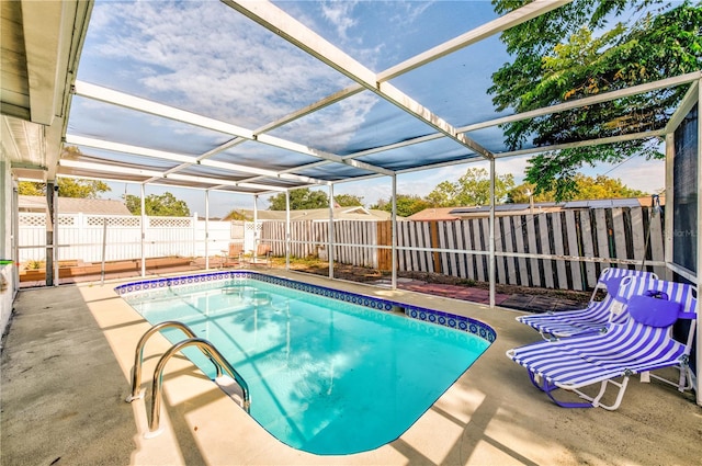 view of pool featuring a patio and glass enclosure