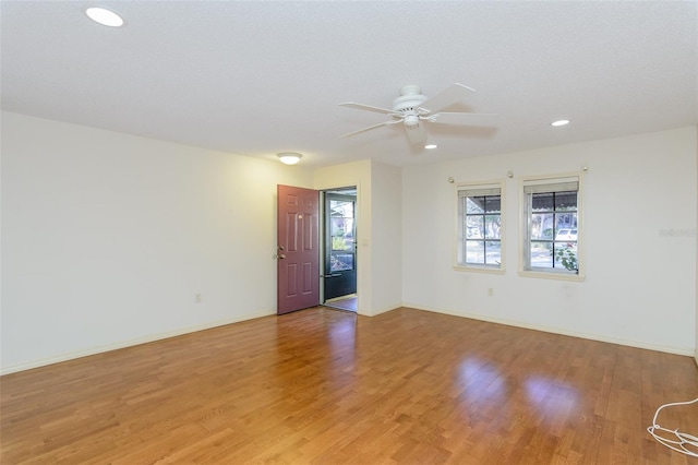 empty room featuring ceiling fan and light wood-type flooring