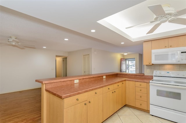 kitchen with ceiling fan, white appliances, kitchen peninsula, and light brown cabinets