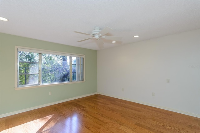 unfurnished room with ceiling fan and light hardwood / wood-style flooring