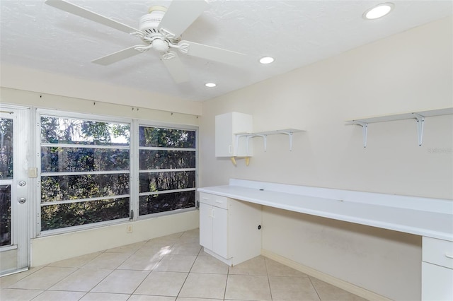 interior space with ceiling fan and light tile patterned flooring